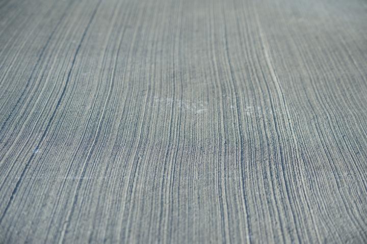 Surface of a concrete screed floor with receding lines in a repeat pattern background texture