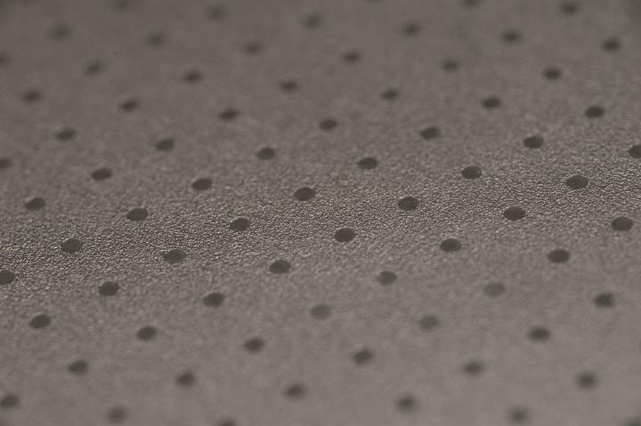 Close up Textured Brown Background Design with Dots Pattern, Emphasizing Copy Space.