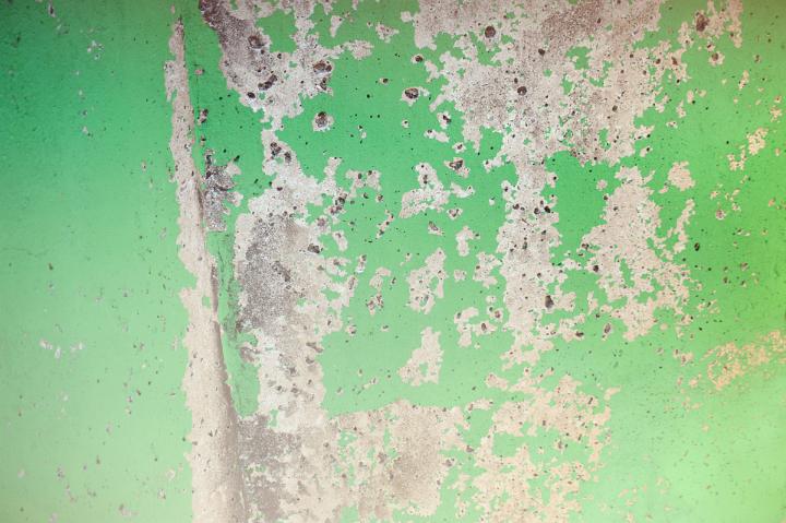 Detail of Chipped Green Paint on Concrete Cement Wall for Backgrounds