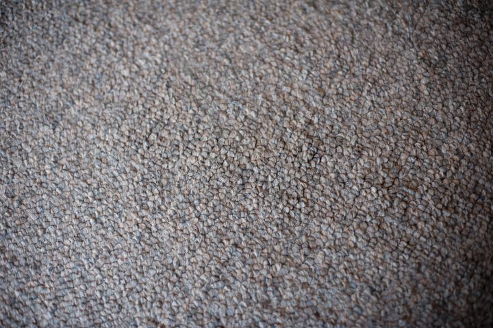 Close up Clean Textured Gray Wool Carpet for Wallpaper Backgrounds, Emphasizing Copy Space on a High Angle Shot.