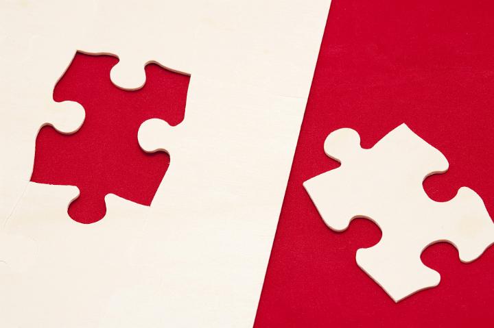 Close up Shot of Red and White Jigsaw Puzzle Game, Emphasizing Problem Solving Concept