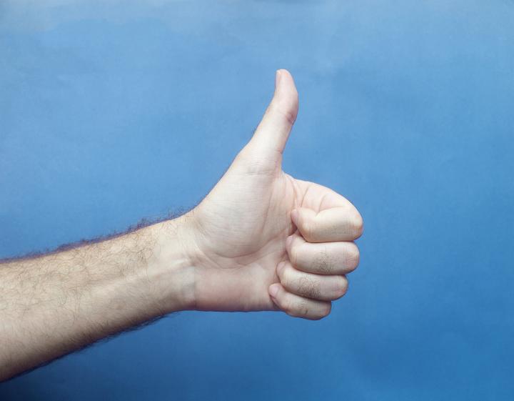 I like this - Male Hand Giving Thumbs Up Sign Giving Approval with Blue Background