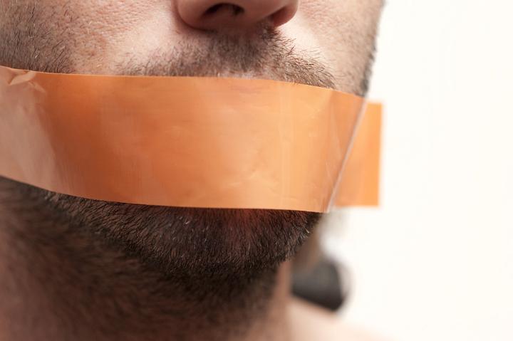 Censor and Freedom of Speech Concept - Close up Man Face with Brown Tape Covering his Mouth.