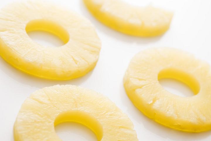 Close-up of pineapple cut in rings against white background
