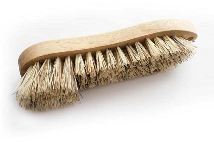 Still Life of Single Cleaning Scrub Brush with Bristles of Various Lengths on White Background from Above