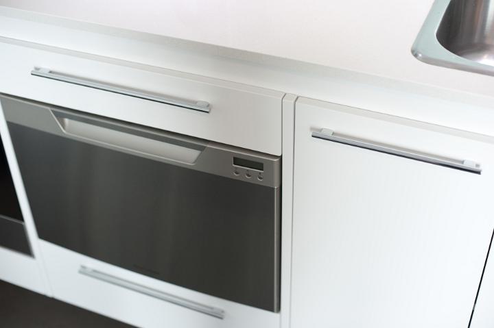 Modern white fan oven with a glass fronted door in a fitted kitchen for cooking the food, close up high angle view