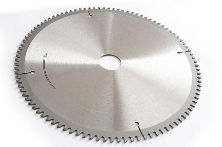 A brand new metal circular saw blade with sharp teeth isolated on a white background with copy space.