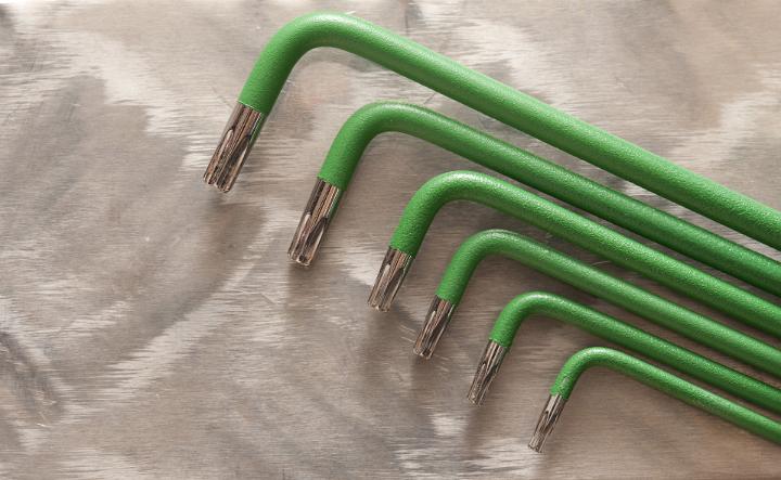 A set of six green star hex keys isolated on a plain background.