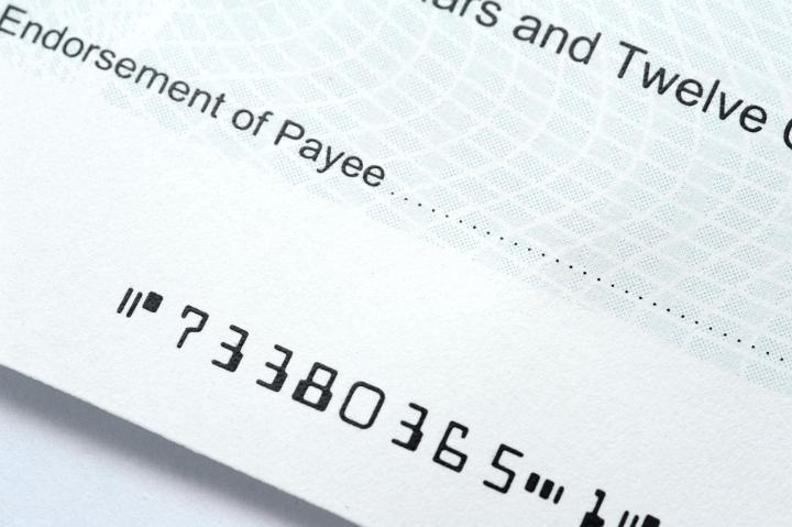 Close up of a bank cheque with blank Payee details in a payment and purchase concept