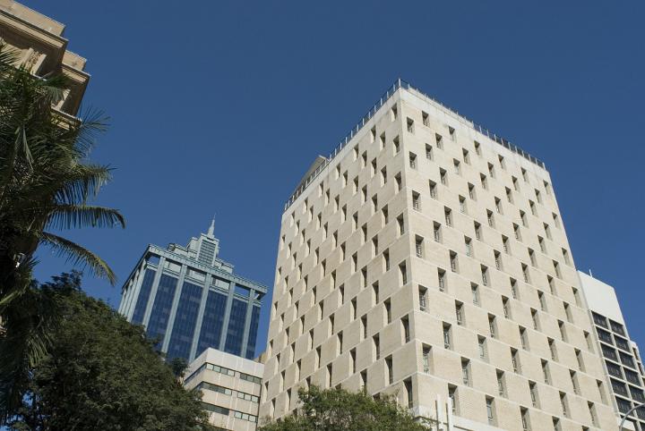 Exterior View of Architectural High City Offices on Blue Gray Sky Background