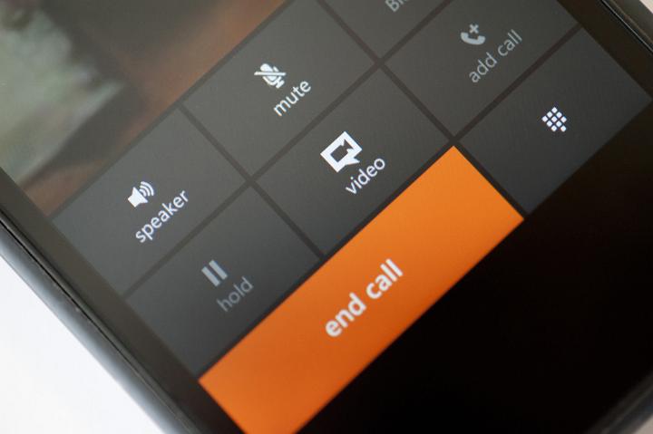 Close up Orange End Call Button on a Black Touch Screen Mobile Phone.