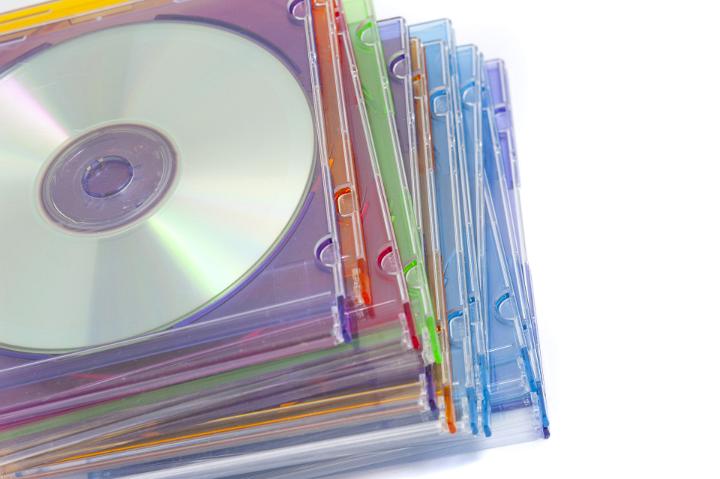 Close up Piled of Colored Compact Disc Cases on White Background.