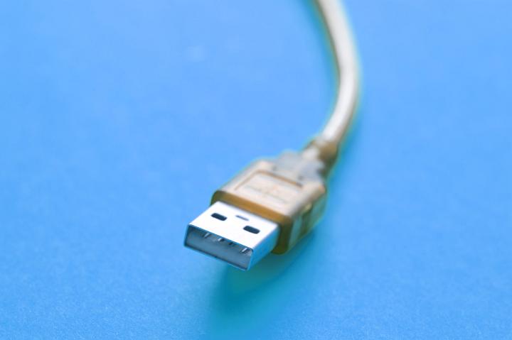 Close up Universal Serial Bus Connector for Computer Devices Isolated on a Blue Background.