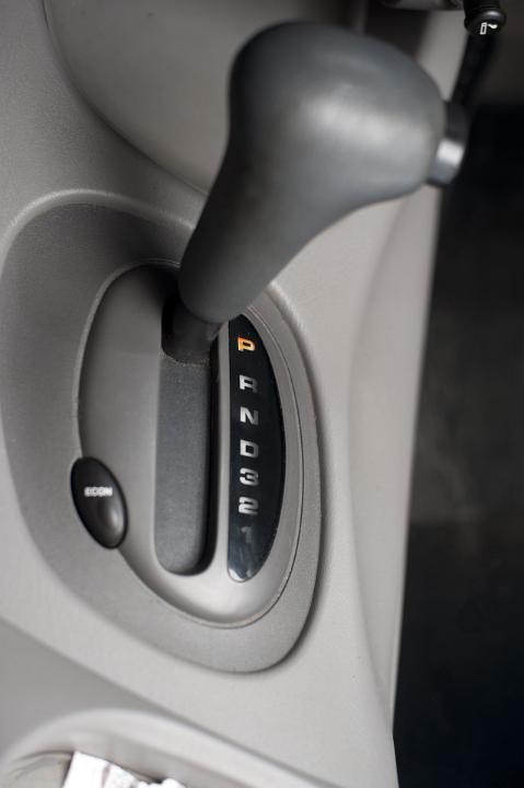 Detail of Automatic Gear Shift Set in Park Position as part of Console in a Grey Vehicle