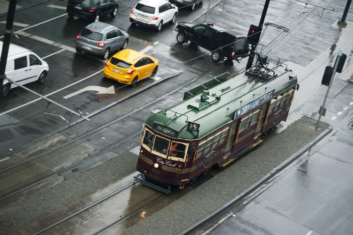 Aerial view of street tram and traffic on rainy day