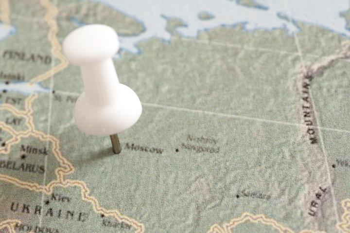 Close Up of White Tack Pin Pointing Travel Location of City of Moscow on Map of Russia