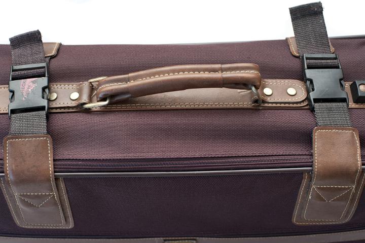 Close Up of Handle on Burgundy Cloth Suitcase Secured with Clips