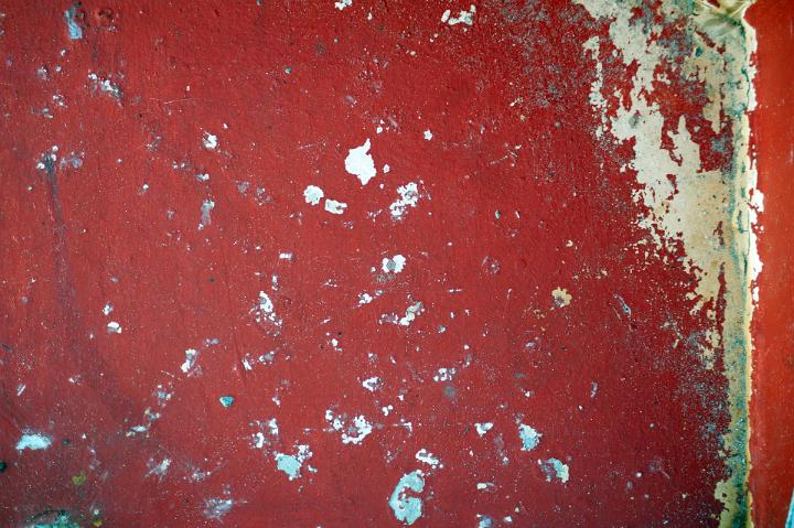 Old Textured Flaked Red Paint on a Wall for Vintage Background Designs, Emphasizing Copy Space.