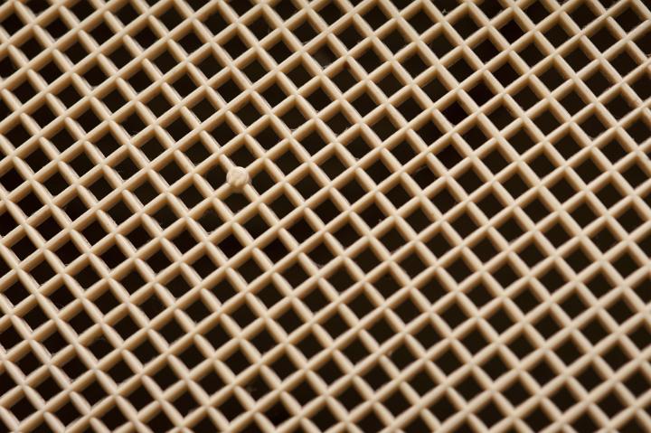 Plastic covered diamond mesh grid background texture and geometric pattern viewed at a slight angle