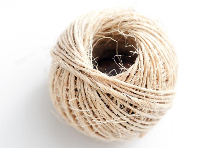 Close up Aerial Shot of Ball of Twine Isolated on White Background