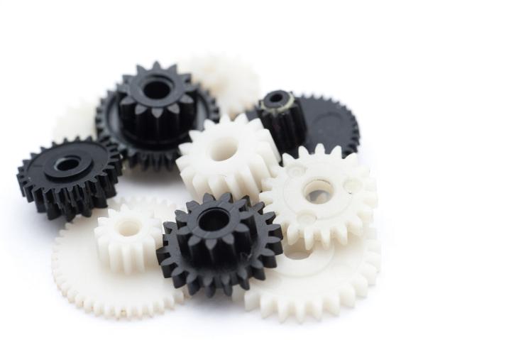 Close up Black and White Plastic Cog Gears Isolated on White Background.