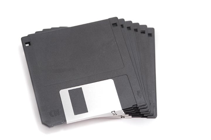 Close up Pile of Gray Computer Diskettes Isolated on White Background.