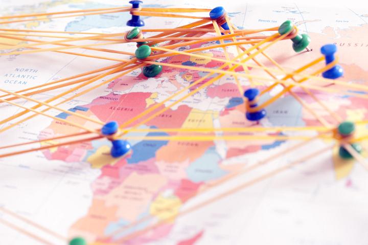 Conceptual image of pins on a map depicting international connections, communications and travel