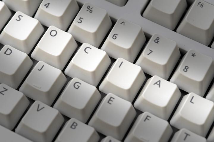 Computer key board social media concept with the letters spelling - social - highlighted in a row depicting internet or online multimedia connectivity and community sharing