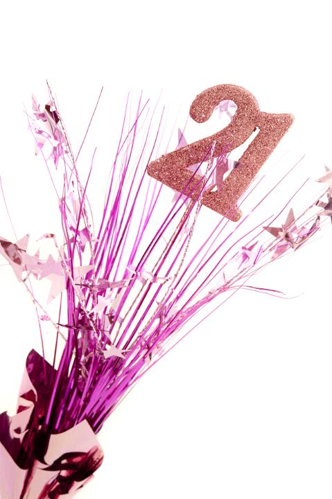 21st birthday celebration with a pink spray of stars around glitter numbers - 21 - isolated on white for a greeting card or invitation for a young girl coming of age