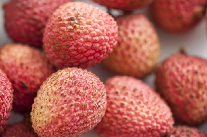 Background texture of ripe tropical lychees or litchis for a tasty sweet juicy snack or dessert