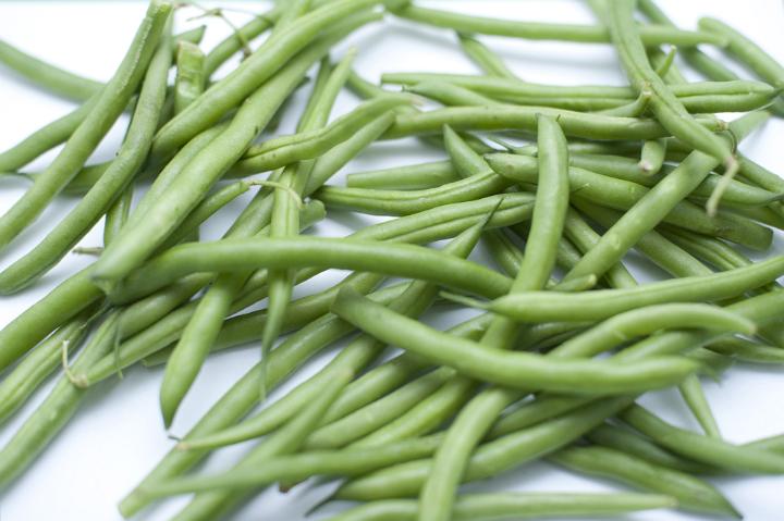Assortment of Fresh Picked Green Snap Beans from Garden on White Background