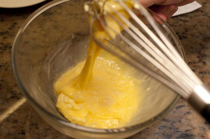 Whisk Beating Eggs in Glass Bowl on Counter Top as part of Meal Preparation or Baking