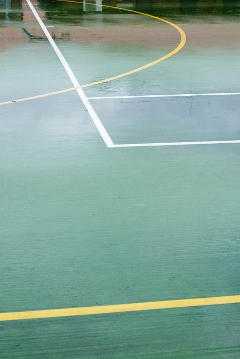 The corner of a tennis or soccer hard court painted on the ground
