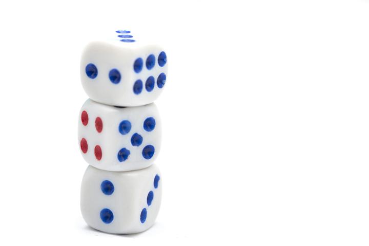 Three Dice with Blue and Red Dots Stacked Vertically on White Background