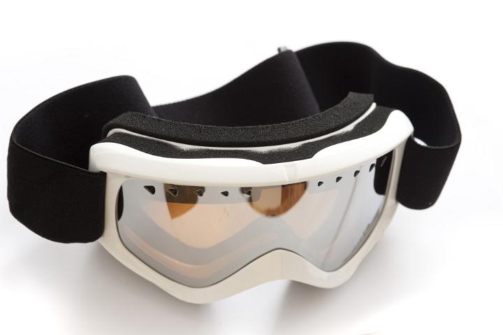 Pair of tinted winter goggles for skiing or snowboarding to protect the eyes from injury and the reflection off the snow
