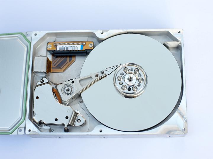 Close up Physical Interior Components of a Computer Hard Disk on a White Background. Captured in Aerial View.
