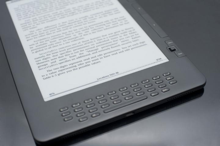 Close Up of E-Reader with Keyboard and Book on Display Screen on Dark Grey Background