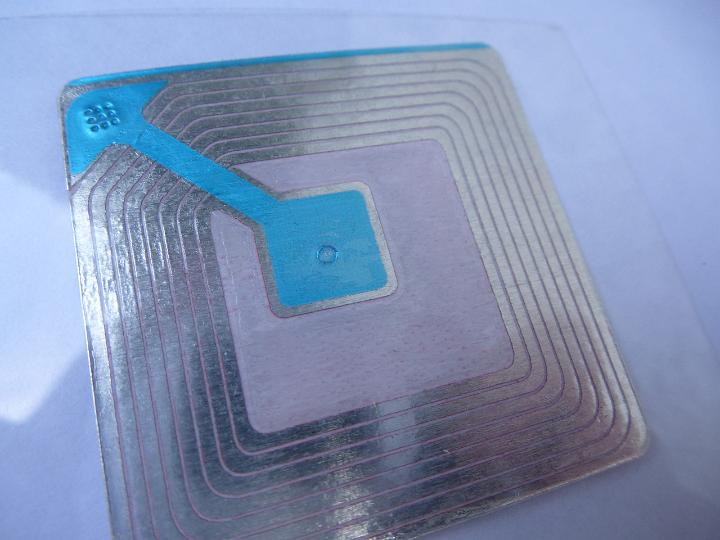 Close Up of Square Silver and Blue RF Security Tag Patch Used to Track Objects