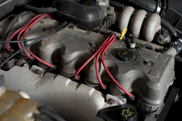 A modern car engine enclosed in the engine bay under the bonnet or hood