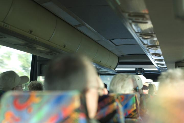 Interior of a tour bus while touring with blurred heads of seated people from behind in a tourism and travel concept
