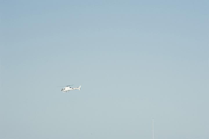 Side View of Helicopter Flying in Big Clear Blue Sky with Copyspace