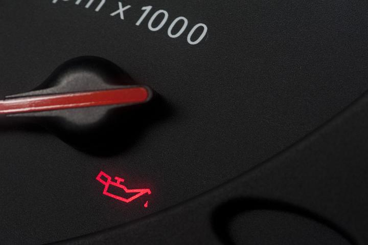 Low oil red warning light on the rev counter of a car illuminated to on starting the ignition or to warn of low engine oil level