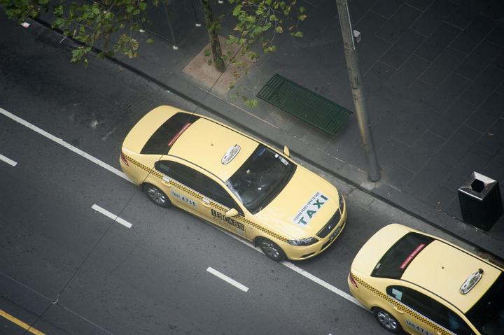 Looking Down at Yellow Taxi Cabs Parked in Queue on City Street