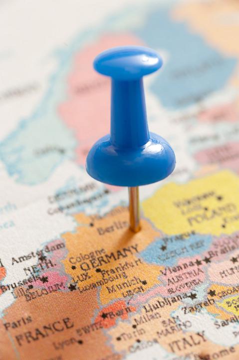 Close Up of Blue Thumb Tack Pin Location Marker Inserted in Map of Berlin, Germany